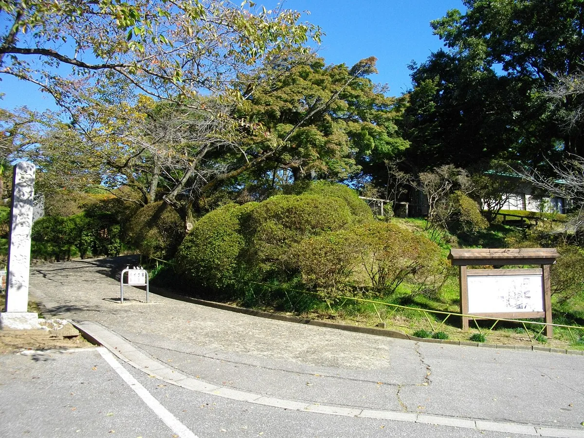 Trees and an information board at Shiroyama Park’s entrance